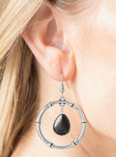 Load image into Gallery viewer, Chiseled into a tranquil teardrop, an earthy black stone swings from the top of a textured silver hoop, creating a handcrafted, artisan inspired lure. Earring attaches to a standard fishhook fitting.  Sold as one pair of earrings.