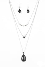 Load image into Gallery viewer, A textured silver bar is suspended horizontally from the uppermost chain above two stone pendants. A dainty black stone hangs from the center most layer as a black stone teardrop swings from the lowermost chain for a bold artisanal finish. Features an adjustable clasp closure.  Sold as one individual necklace. Includes one pair of matching earrings.