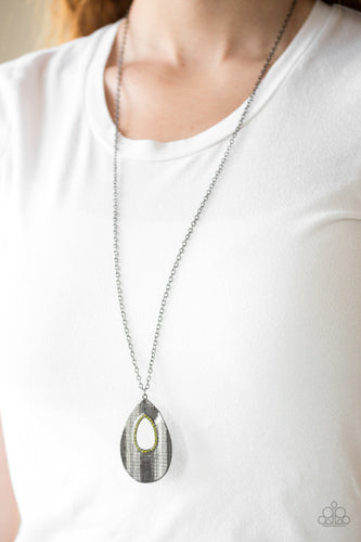   Embossed in a linear geometric pattern, a warped gunmetal teardrop swings from the bottom of a lengthened gunmetal chain. Glittery green rhinestones are encrusted around the center of the teardrop pendant for a sparkling finish. Features an adjustable clasp closure.  Sold as one individual necklace. Includes one pair of matching earrings. Always nickel and lead free.