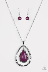 A purple bead is pressed into the center of a delicately hammered silver frame. The colorful teardrop swings from the top of a silver teardrop silhouette, creating an airy pendant. Features an adjustable clasp closure.  Sold as one individual necklace. Includes one pair of matching earrings.