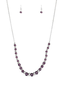 Varying in size, shiny silver beads, textured silver accents, and purple crystal-like beads are threaded along an invisible wire at the bottom of a lengthened silver chain for a refined flair. Features an adjustable clasp closure.  Sold as one individual necklace. Includes one pair of matching earrings.