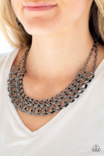 Load image into Gallery viewer, Asymmetrical gunmetal frames connect below the collar, creating a bold web-like fringe for a statement-making look. Features an adjustable clasp closure.  Sold as one individual necklace. Includes one pair of matching earrings.  Always nickel and lead free. 