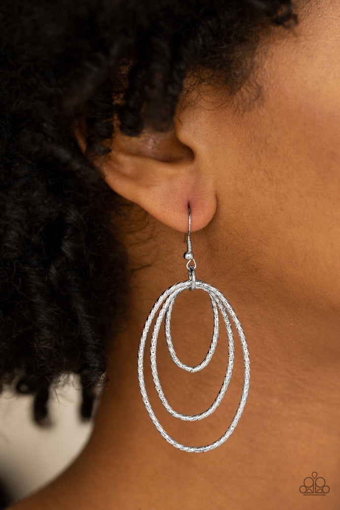 Rippling with diamond-cut shimmer, glistening silver hoops trickle from the ear for a casual look. Earring attaches to a standard fishhook fitting.  Sold as one pair of earrings.  Always nickel and lead free.