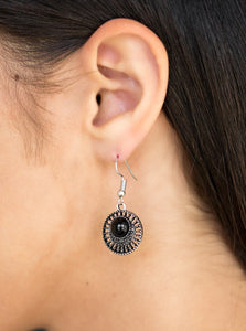 A shiny black bead is pressed into an airy silver frame radiating with studded textures for a seasonal look. Earring attaches to a standard fishhook fitting.  Sold as one pair of earrings.