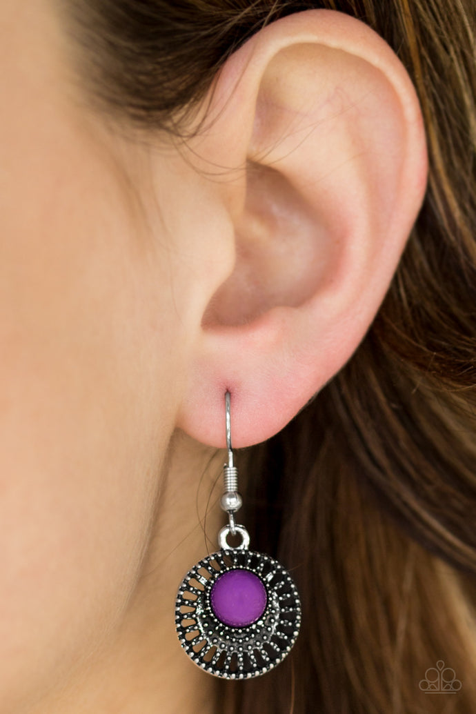 A vivacious purple bead is pressed into an airy silver frame radiating with studded textures for a seasonal look. Earring attaches to a standard fishhook fitting.  Sold as one pair of earrings.