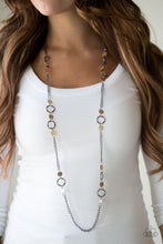 Load image into Gallery viewer, Delicately hammered in shimmery textures, glistening gold discs and abstract gunmetal hoops trickle along a bold gunmetal chain for a fierce industrial look. Features an adjustable clasp closure.  Sold as one individual necklace. Includes one pair of matching earrings.  Always nickel and lead free.