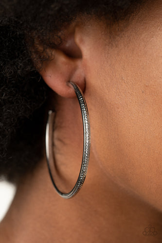 Featuring shimmery diamond-cut texture, a glistening gunmetal bar lines the center of a beveled gunmetal hoop, creating an edgy stacked look. Earring attaches to a standard post fitting. Hoop measures approximately 2 1/2