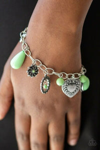 Stunning silver charms featuring charming multiple patterns dangle from a simple silver chain. Infused with green stones create a playful combination. Features an adjustable clasp closure.  Sold as one individual bracelet.  Always nickel and lead free.