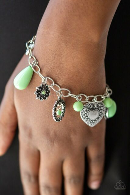 Stunning silver charms featuring charming multiple patterns dangle from a simple silver chain. Infused with green stones create a playful combination. Features an adjustable clasp closure.  Sold as one individual bracelet.  Always nickel and lead free.