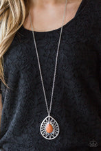 Load image into Gallery viewer,   A vivacious orange stone is pressed into the center of a large silver teardrop radiating with shimmery sunburst patterns. The tribal inspired pendant swings from the bottom of a lengthened silver chain for a dramatic look. Features an adjustable clasp closure.  Sold as one individual necklace. Includes one pair of matching earrings.  Always nickel and lead free.