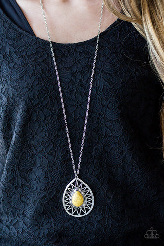   A sunny yellow stone is pressed into the center of a large silver teardrop radiating with shimmery sunburst patterns. The tribal inspired pendant swings from the bottom of a lengthened silver chain for a dramatic look. Features an adjustable clasp closure.  Sold as one individual necklace. Includes one pair of matching earrings.  Always nickel and lead free.
