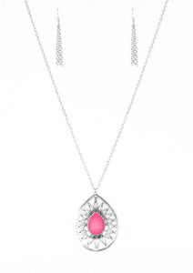 A vivacious pink stone is pressed into the center of a large silver teardrop radiating with shimmery sunburst patterns. The tribal inspired pendant swings from the bottom of a lengthened silver chain for a dramatic look. Features an adjustable clasp closure.  Sold as one individual necklace. Includes one pair of matching earrings.