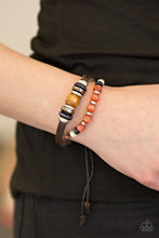 Load image into Gallery viewer, Featuring an array of glassy, wooden, and metallic accents, a strand of leather and brown twine layer across the wrist for an urban look. Features an adjustable sliding knot closure.  Sold as one individual bracelet.  Always nickel and lead free.