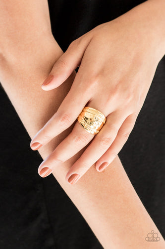 Ribbons of circular texture are embossed along the borders of a hammered gold band for an edgy look. Features a stretchy band for a flexible fit.  Sold as one individual ring.   Always nickel and lead free.