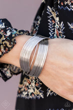 Load image into Gallery viewer, Threaded along two metallic rods, glistening silver bands crisscross across the wrist, creating the illusion of countless silver bangles in the convenience of a simple layered cuff.  Sold as one individual bracelet.