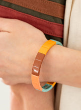 Load image into Gallery viewer, Metal rectangles painted in the spring Pantone® shades of Cerulean, Rust, Marigold, and Burnt Coral are threaded along stretchy bands, forming a gorgeous spectrum of color that wraps around the wrist.