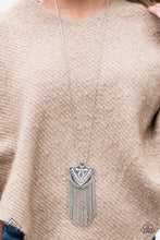 Load image into Gallery viewer, Infused with a lengthened silver chain, a silver arrowhead-like pendant boldly swings from the bottom of glistening silver chain. Radiating in studded detail, the tribal inspired pendant gives way to a shimmery chain fringe for a seasonal finish. Features an adjustable clasp closure.  Sold as one individual necklace. Includes one pair of matching earrings.   Sunset Sightings Fashion Fix  March 2018  Always nickel and lead free.
