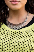 Load image into Gallery viewer, Featuring crisscrossed detail, dainty silver frames link below the collar, giving way to a dramatic half-moon plate radiating with dizzying tribal details for a fierce look. Features an adjustable clasp closure.  Sold as one individual necklace. Includes one pair of matching earrings.  Sunset Sightings Fashion Fix February 2020 Always nickel and lead free.
