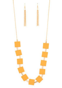 Vibrant geometric squares painted in the spring Pantone® of Marigold flare out along a long gold chain as it drapes along the chest. Sleek gold cylinders separate the square plates, adding warm metallic accents to the piece. Features an adjustable clasp closure.