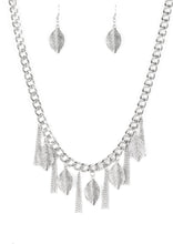 Load image into Gallery viewer, Decorated in lifelike textures, glistening silver leaves swing from the bottom of a bold silver chain. Infused with sections of silver chain tassels, the leafy fringe drapes below the collar for a seasonal look. Features an adjustable clasp closure.  Sold as one individual necklace. Includes one pair of matching earrings.