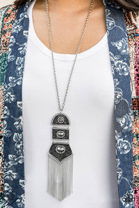 Silver beads encircled by rhinestones are nestled inside a row of three vintage frames that cascade down the chest at the bottom of an elongated silver chain. Glistening silver chains stream from the bottom of the stacked pendant, creating a gorgeously tapered tassel. Features an adjustable clasp closure.