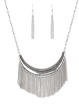 Load image into Gallery viewer, Brushed in an antiqued finish, glistening silver chains stream from the bottom of a silver crescent, creating a bold fringe below the collar for a fierce look. Features an adjustable clasp closure.  Sold as one individual necklace. Includes one pair of matching earrings.