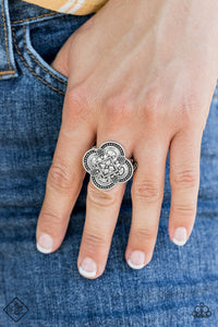  Embossed in a whimsical floral pattern, a scalloped silver frame swirls atop the finger for a seasonal flair. Features a stretchy band for a flexible fit.