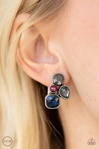 Infused with a dainty purple pearl, mismatched blue, smoky, and hematite rhinestones coalesce into a glittery frame. Earring attaches to a standard clip-on fitting.  Sold as one pair of clip-on earrings.  Always nickel and lead free.  .