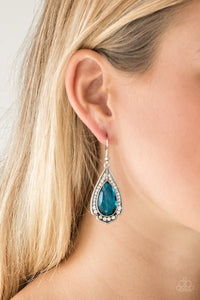 Featuring a regal teardrop cut, a blue gem is pressed into a silver spade shape frame radiating with glassy white rhinestones for a refined look. Earring attaches to a standard fishhook fitting.  Sold as one pair of earrings.   Always nickel and lead free