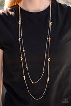 Load image into Gallery viewer, Golden crystal-like beads trickle along two strands of shimmery gold chain, creating glittery accents across the chest. Features an adjustable clasp closure.  Sold as one individual necklace. Includes one pair of matching earrings.  Always nickel and lead free.