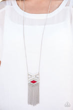 Load image into Gallery viewer, Stamped in triangular patterns, a dramatic tribal inspired pendant swings from the bottom of a shimmery silver chain in an indigenous fashion. Shimmery silver chains stream from the bottom of the pendant as a fiery red bead is pressed into the frame for a colorful finish. Features an adjustable clasp closure.  Sold as one individual necklace. Includes one pair of matching earrings.