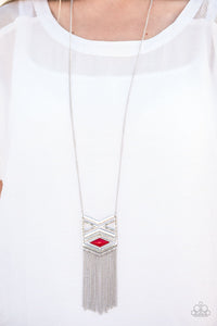 Stamped in triangular patterns, a dramatic tribal inspired pendant swings from the bottom of a shimmery silver chain in an indigenous fashion. Shimmery silver chains stream from the bottom of the pendant as a fiery red bead is pressed into the frame for a colorful finish. Features an adjustable clasp closure.  Sold as one individual necklace. Includes one pair of matching earrings.
