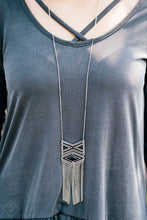 Load image into Gallery viewer, Stamped in triangular patterns, a dramatic tribal inspired pendant swings from the bottom of a shimmery silver chain in an indigenous fashion. Shimmery silver chains stream from the bottom of the pendant as a black bead is pressed into the frame for a colorful finish. Features an adjustable clasp closure.  Sold as one individual necklace. Includes one pair of matching earrings.  Always nickel and lead free.