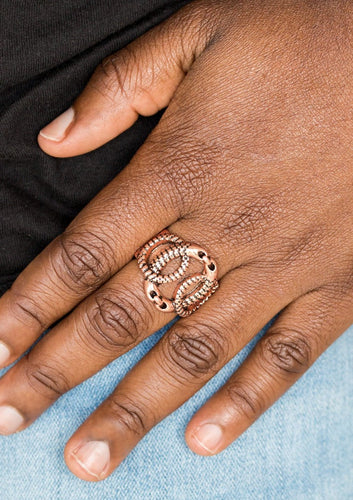 Etched in edgy asymmetrical textures, three glistening copper rings link across the finger, creating a bold industrial centerpiece. Features a stretchy band for a flexible fit.  Sold as one individual ring.  Always nickel and lead free.