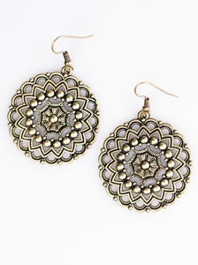 Brushed in an antiqued shimmer, brass bars and brass studs spin into a kaleidoscopic pattern for a whimsical fashion