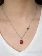 Load image into Gallery viewer, A faceted red bead swings from the bottom of a shimmery silver chain. A smoky rhinestone adorns one side for a sleek asymmetrical finish. Features an adjustable clasp closure.  Sold as one individual necklace. Includes one pair of matching earrings.