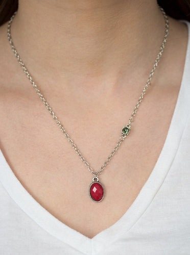 A faceted red bead swings from the bottom of a shimmery silver chain. A smoky rhinestone adorns one side for a sleek asymmetrical finish. Features an adjustable clasp closure.  Sold as one individual necklace. Includes one pair of matching earrings.