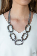 Load image into Gallery viewer, Delicately hammered in blinding shimmer, over sized shiny gunmetal chain links and textured fittings connect below the collar. Suspended from strands of gunmetal chains, the bold links catch and reflect the light for a statement-making finish. Features an adjustable clasp closure.  Sold as one individual necklace. Includes one pair of matching earrings.  Always nickel and lead free.  Life of the Party Exclusive