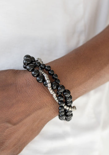 Strands of black beads and metallic seed beads weave around the wrist for a seasonal look. Features an adjustable clasp closure.  Sold as one individual bracelet.
