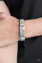 Load image into Gallery viewer, Brushed in an antiqued finish, a life-like leaf is embossed in the center of a silver plate. Gray leather bands loop through the silver centerpiece and are studded in place across the wrist for a seasonal look. Features an adjustable snap closure.  Sold as one individual bracelet.  Always nickel and lead free.