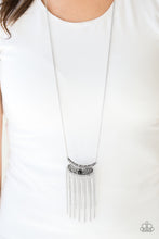 Load image into Gallery viewer, Embossed in vine-like patterns, a stacked silver pendant gives way to a shimmery silver fringe. Infused with an elongated silver chain, a dainty black bead is pressed into the center of the antiqued pendant for a colorful finish. Features an adjustable clasp closure.  Sold as one individual necklace. Includes one pair of matching earrings.  Always nickel and lead free.