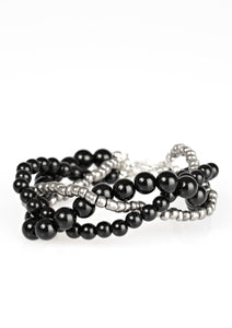 Strands of black beads and metallic seed beads weave around the wrist for a seasonal look. Features an adjustable clasp closure.  Sold as one individual bracelet.