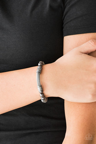 Pearly gunmetal beads, ornate gunmetal accents, and sections of gunmetal mesh chain are threaded along a stretchy band around the wrist for a refined flair.  Sold as one individual bracelet.  Always nickel and lead free.