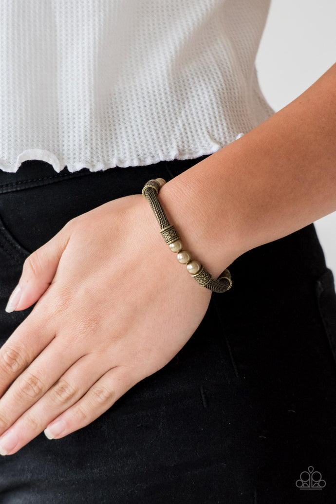 Pearly brass beads, ornate brass accents, and sections of brass mesh chain are threaded along a stretchy band around the wrist for a refined flair.  Sold as one individual bracelet.  Always nickel and lead free.