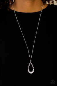Swinging from the bottom of an elongated silver chain, the bottom of a glistening silver teardrop is encrusted in glassy white rhinestones, creating a refined pendant. Features an adjustable clasp closure.  Sold as one individual necklace. Includes one pair of matching earrings.  Always nickel and lead free.