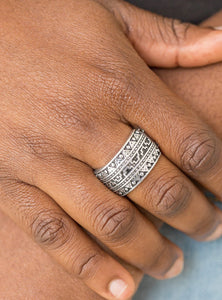 Brushed in an antiqued shimmer, a glistening silver band is embossed in stunning textile patterns for a seasonal look. Features a stretchy band for a flexible fit.  Sold as one individual ring.