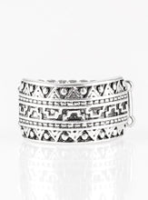 Load image into Gallery viewer, Brushed in an antiqued shimmer, a glistening silver band is embossed in stunning textile patterns for a seasonal look. Features a stretchy band for a flexible fit.  Sold as one individual ring.