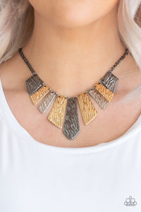 Embossed in rippling patterns, a collection of angular silver, gunmetal, and gold plates swing from the bottom of a glistening gunmetal chain, creating an edgy geometric fringe below the collar. Features an adjustable clasp closure.  Sold as one individual necklace. Includes one pair of matching earrings.  Always nickel and lead free. 