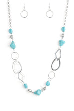 Load image into Gallery viewer, Bits of refreshing turquoise stones and ornate silver beading give way to asymmetrical silver frames. The mismatched frames drape across the chest, creating an earthy collision of rock and metal. Features an adjustable clasp closure.  Sold as one individual necklace. Includes one pair of matching earrings.