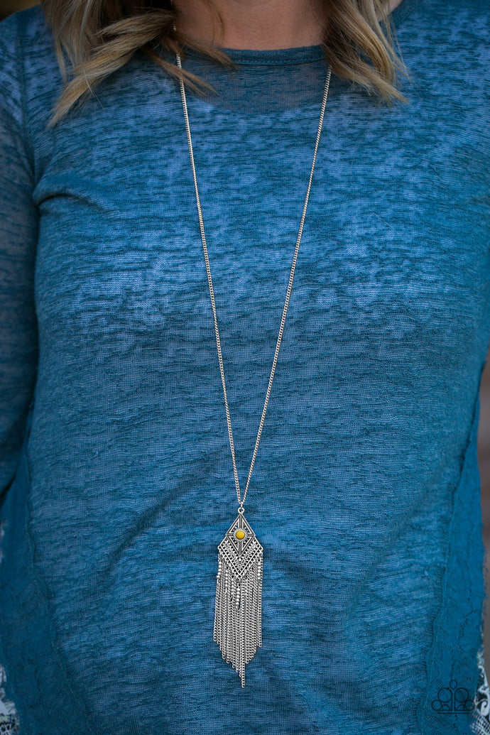A bright yellow bead is pressed into the center of a kite-shaped pendant. Embossed in tactile textures, the shimmery pendant gives way to a whimsical chain tassel featuring dainty beaded accents. Features an adjustable clasp closure.  Sold as one individual necklace. Includes one pair of matching earrings.  Always nickel and lead free.